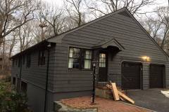 Shoreham painters restore the exterior of a home by painting it black.