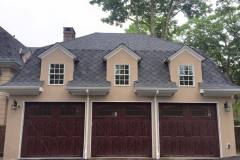Exterior garage siding, trim and doors refinished by Long Island Painters