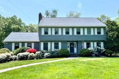 House on Long Island painted gray with white trim and shutters by Long Island Professional Painters