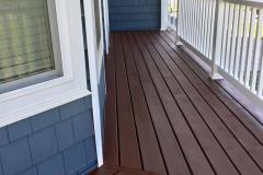 Long Island painter refinishes a front porch deck and stains it gray in Suffolk County, NY