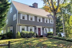 Long Island House Painting services provided by American Made Painting restore a entire exterior of a home by painting it gray with white trim and red door.