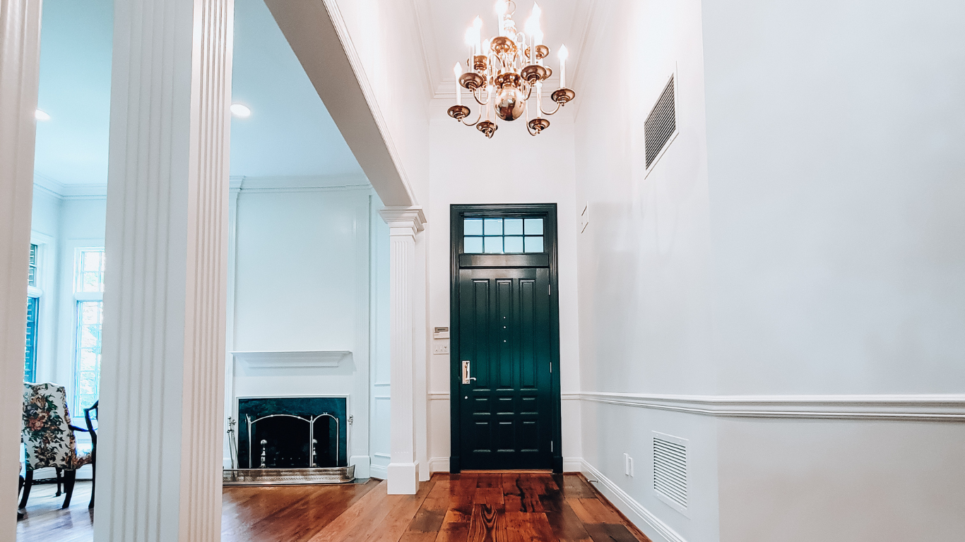 Front entryway foyer painted white and door painted black by Long Island House painters.